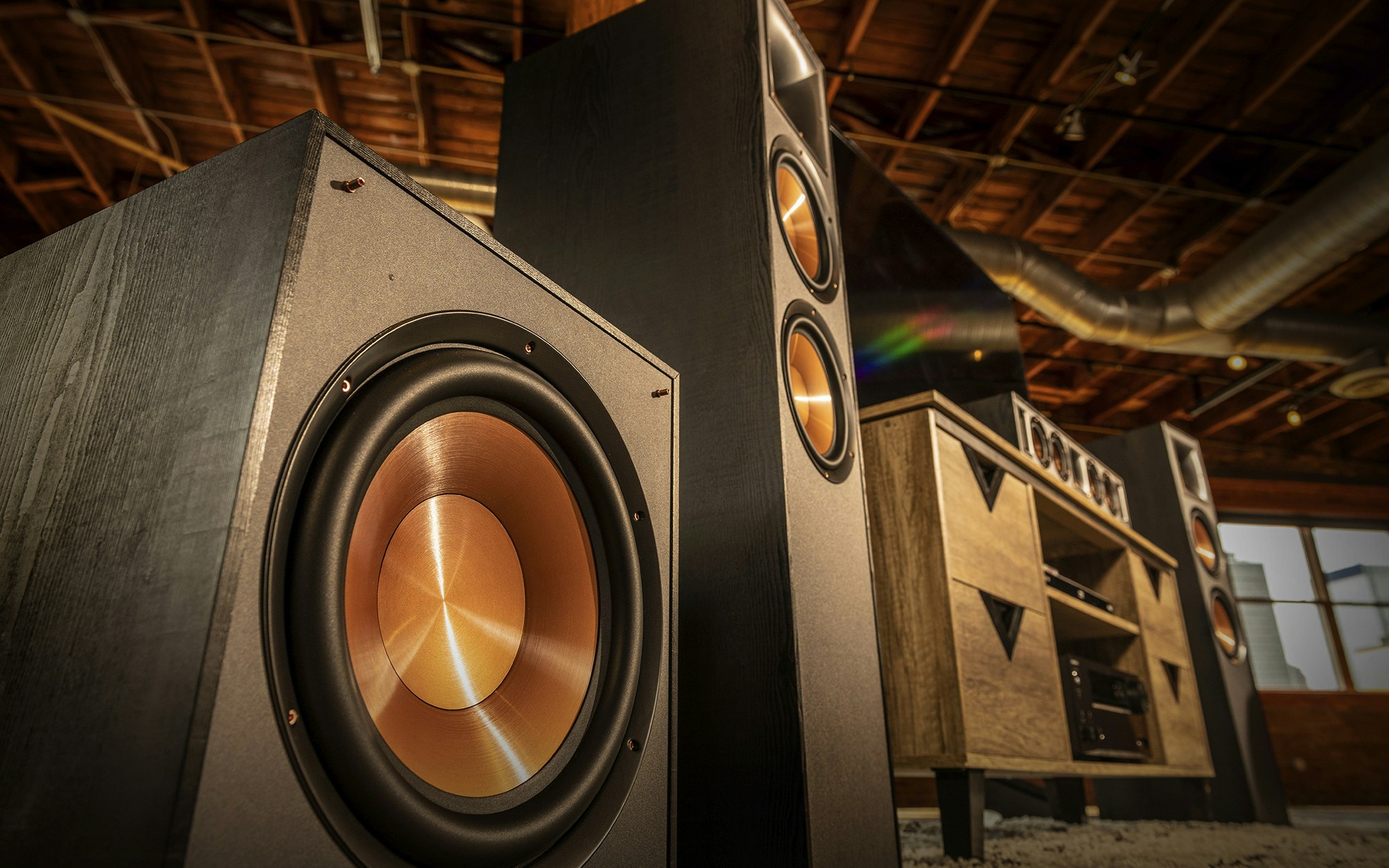 Close up of a Klipsch speaker system surrounding a tv